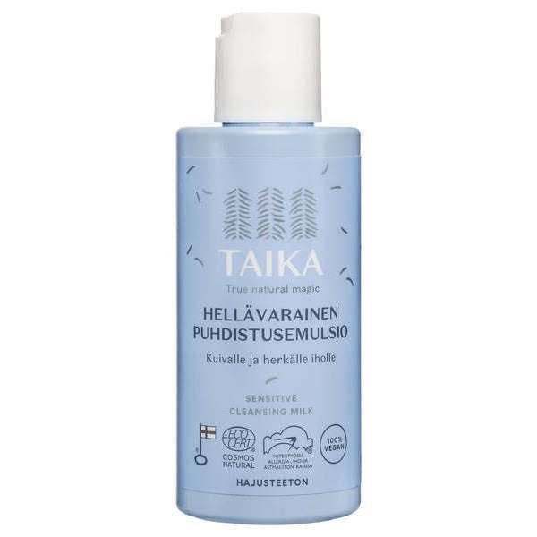 A light blue bottle of Taika Sensitive Cleansing Milk for dry and sensitive skin, featuring Finnish and English text, certification logos, and a white flip-top cap.