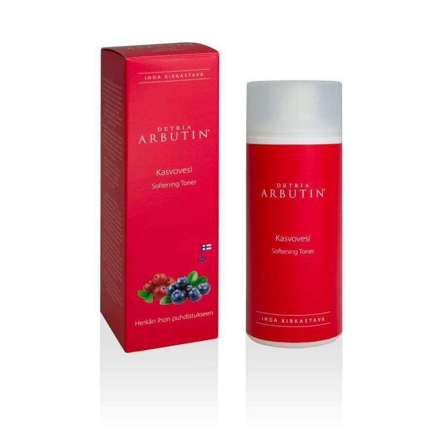 A red box and bottle of Detria Arbutin Softening Toner, a soothing toner for hyperpigmentation, feature berry illustrations, the product name in Finnish and English, and a small Finnish flag icon on the box. Brand: Detria Arbutin.