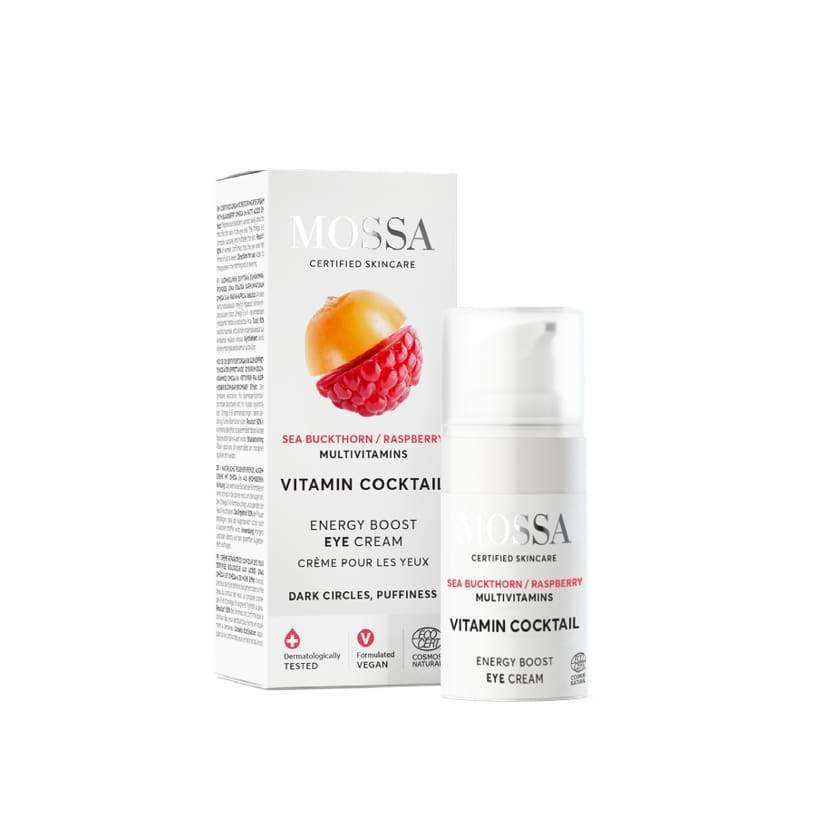 A white bottle and box of Mossa Vitamin Cocktail Energy Boost Eye Cream, enriched with hyaluronic acid, sea buckthorn, and raspberry. Packaging highlights dark circle and puffiness benefits, plus vegan and dermatologically tested symbols.