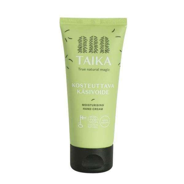A light green tube of Taika Hand Cream with a black cap displays Finnish and English text plus small icons that highlight its natural and vegan features.