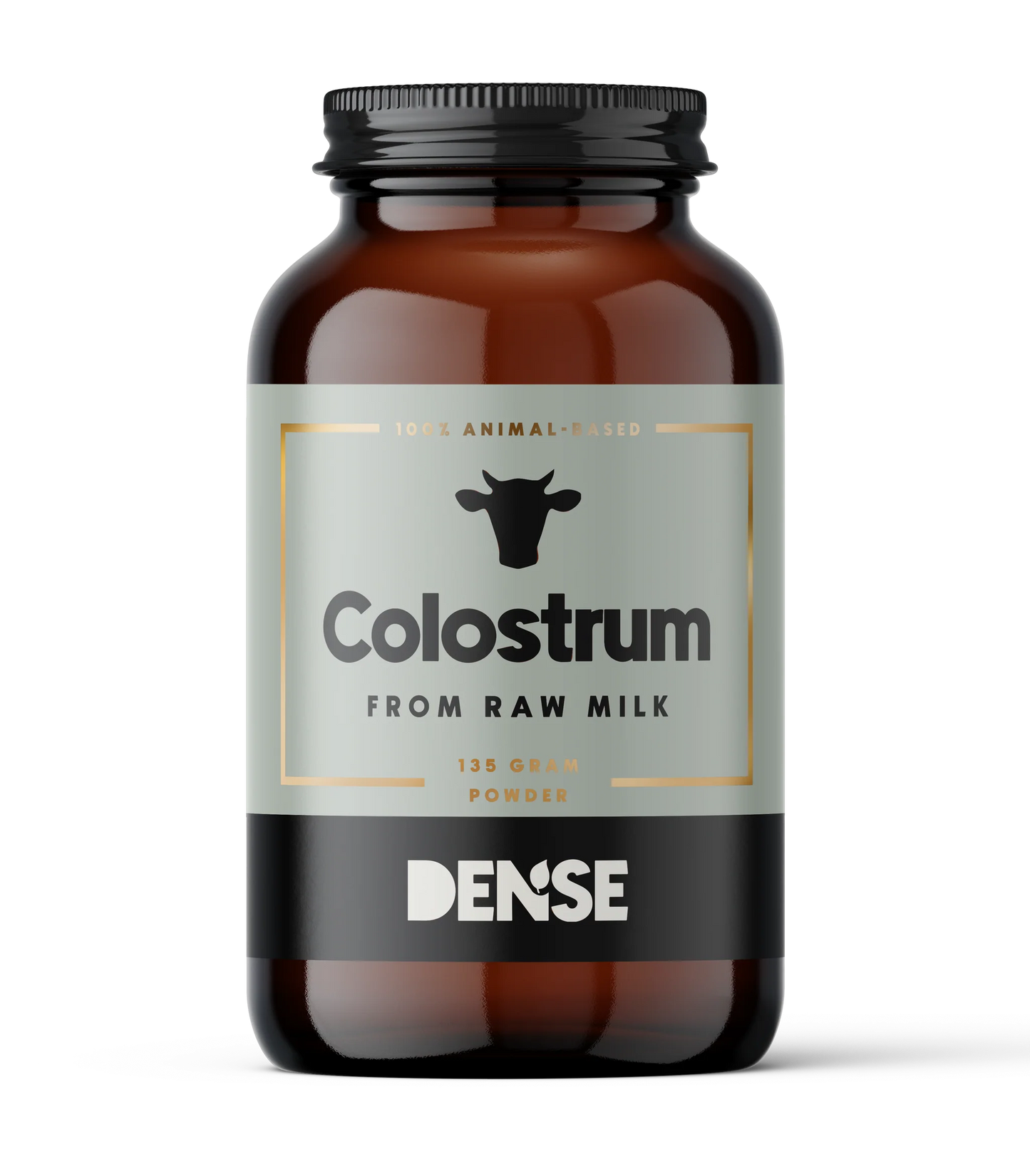A brown glass jar labeled DENSE Colostrum, a 135g dietary supplement from DENSE, features a black cow icon and "Colostrum Powder from Raw Milk" text on a light background.