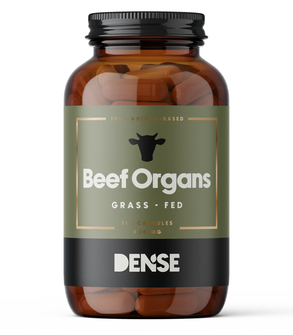 A brown bottle labeled DENSE Beef Organs shows a cow head silhouette and contains 180 capsules (400 mg each) of freeze-dried organ supplements. The label reads 100% Animal-Based dietary supplement by DENSE.