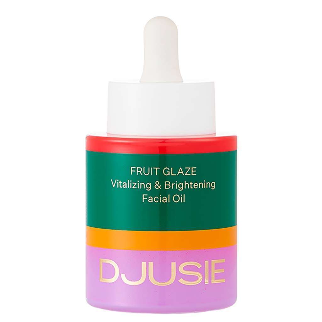 A vibrant bottle of Djusie Fruit Glaze Vitalizing & Brightening Face Oil by Djusie features a white dropper cap, green label with gold text, and red, orange, and purple accents.