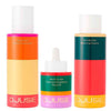 The Djusie Full Bloom Box Skincare Set features three colorful products: a cleansing oil, a facial oil with dropper, and a balancing essence—each with bold color block labels.