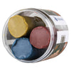 A clear round container from Wennström holds three Forest Plasticine face paint sticks in brown, green-yellow, and blue shades, arranged side by side.