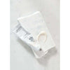 A white tube of Laponie of Scandinavia Face Cream rests on parchment beside a dab of cream, all atop light marble—a gentle formula by Laponie of Scandinavia for sensitive skin.