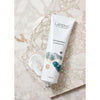 A tube of Laponie of Scandinavia Milk Cleanser rests on marble, with a dab of the gentle formula beside it. The 100 ml tube displays abstract art and text noting it's a cleanser for sensitive skin by Laponie of Scandinavia.