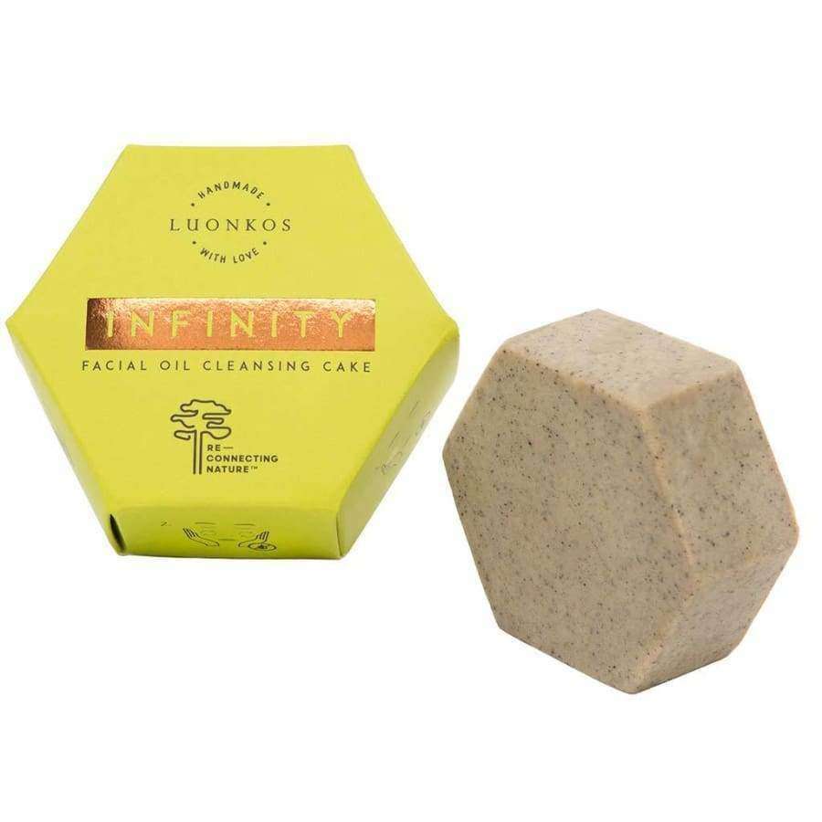 A hexagonal Luonkos Infinity Oil Cleansing Cake rests beside its matching yellow box, making it ideal for sensitive skin.