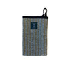 The Metsä/Skogen Linen Wash Glove by Metsä/Skogen is a rectangular striped pouch with a loop handle and META WEAVING label, made in Finland in beige, brown, and light blue tones. Shown against a white background.