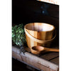 The Emendo Sauna Fragrance Forest by Emendo sits on a wooden bench, ready to infuse your sauna rituals with the calming scent of the forest.