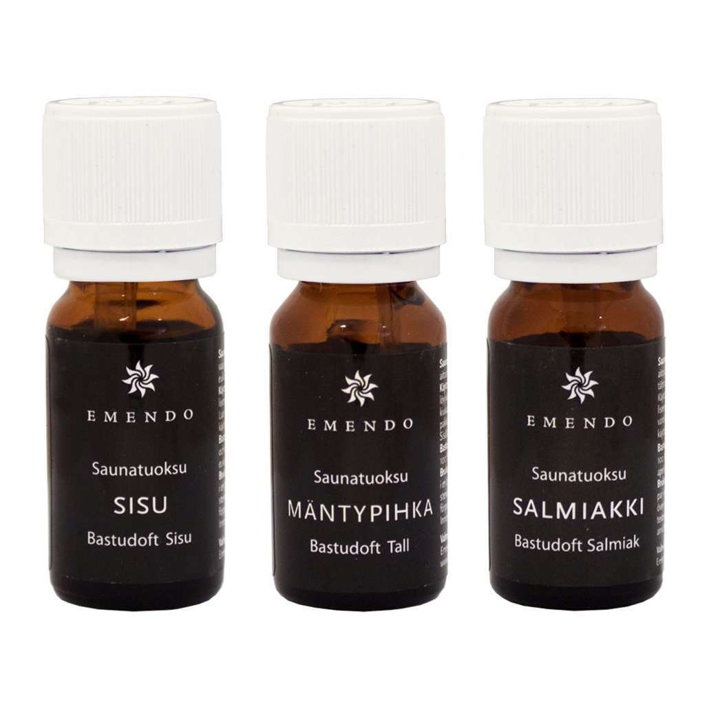 Three small Emendo bottles labeled "Emendo Sauna Fragrance Salmiac, Pine & Sisu" contain Finnish-made sauna fragrances. The brown glass bottles have white caps and black labels with white Finnish text.