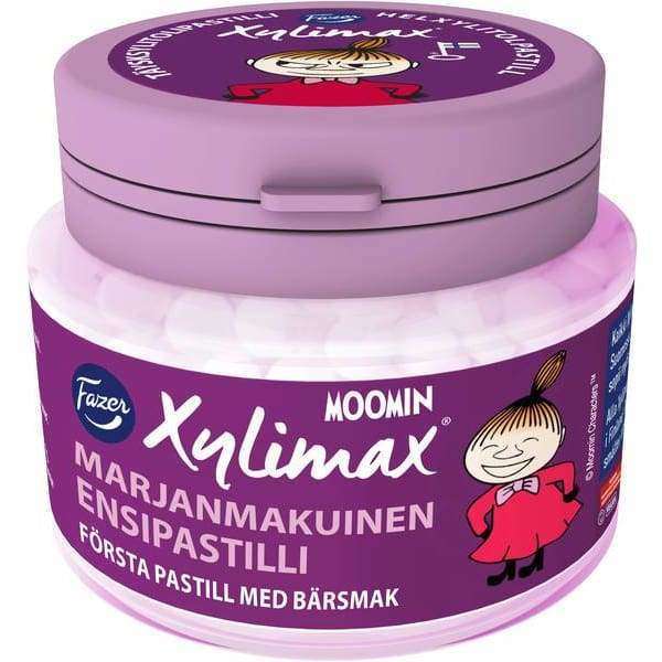 A round purple jar of Fazer Xylimax Moomin Little My Full Xylitolpastill features the cartoon character Little My in a red dress, with Finnish and Swedish text. This popular vegan Fazer candy has a berry flavor.