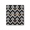 A square bar of Goodio Organic Chocolate Sea Salt features a black and white geometric wrapper with gold text: Goodio Craft Chocolate, Stone Ground, Helsinki, 77% raw Congo cacao, Raw Organic Vegan, 48g (1.7oz).