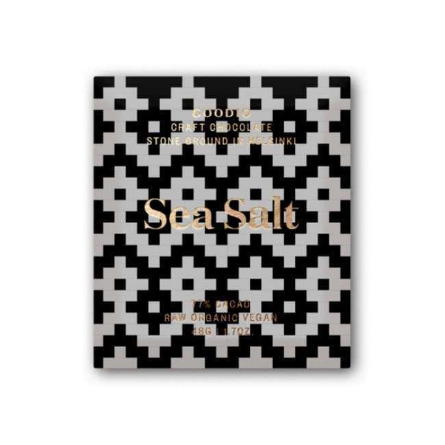 A square bar of Goodio Organic Chocolate Sea Salt features a black and white geometric wrapper with gold text: Goodio Craft Chocolate, Stone Ground, Helsinki, 77% raw Congo cacao, Raw Organic Vegan, 48g (1.7oz).