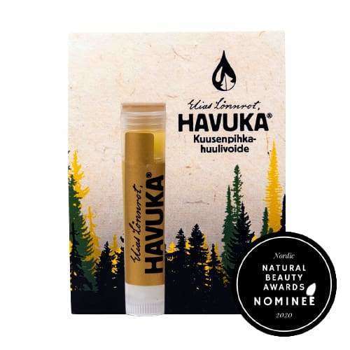 The Havuka Spruce Resin Lip Balm comes in forest-themed packaging. A black badge shows it was a 2020 Nordic Natural Beauty Awards nominee and highlights its nourishing spruce resin formula.