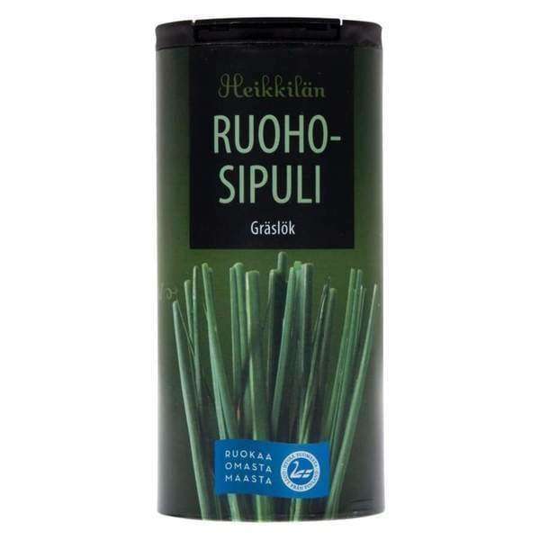A cylindrical container labeled Heikkilä's Chives, from the brand Heikkilä's, displays fresh chives on the front and describes their mild onion flavor and culinary versatility.