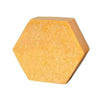 The Luonkos Celebrate Body Cake, a yellow hexagon-shaped block with a textured surface and infused with sea-buckthorn oil, is displayed against a plain white background.