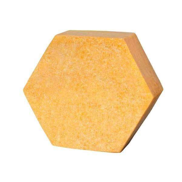 The Luonkos Celebrate Body Cake, a yellow hexagon-shaped block with a textured surface and infused with sea-buckthorn oil, is displayed against a plain white background.