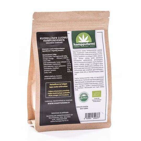 A brown paper package of Nordic Hempfarm Organic Hemp Seed stands upright, showing its black and green label with product details and Finnish logos. The resealable zip keeps these omega-3-rich seeds fresh and suitable for a ketogenic diet.